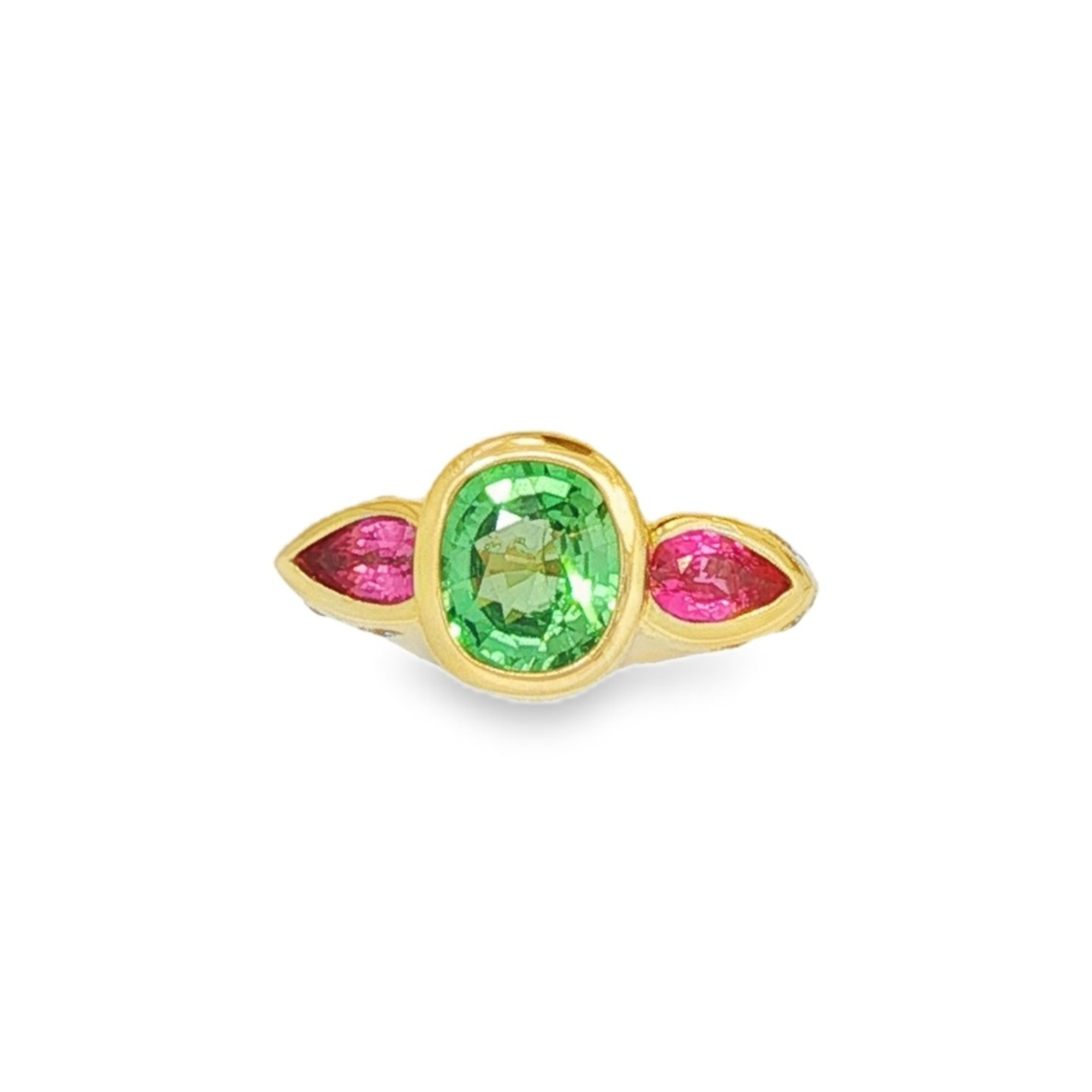 An 18k yellow gold bezel-set gemstone trio ring featuring a 2.18ct tsavorite, 0.80ct pink spinel, and 0.15ct of natural diamonds in a bold modern design.